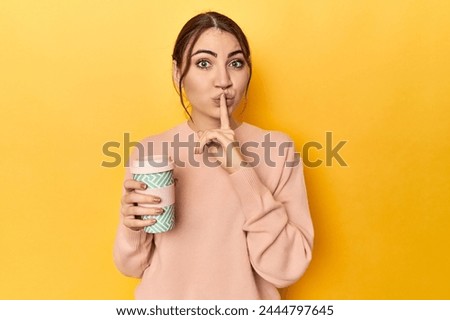 Young caucasian woman holding a takeaway coffee cup keeping a secret or asking for silence.