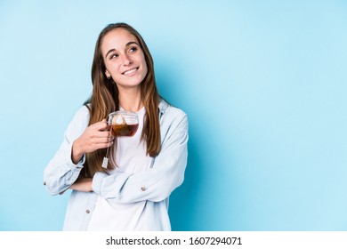 Young Caucasian Woman Holding A Tea Isolated Smiling Confident With Crossed Arms.