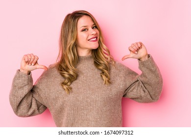 Young caucasian woman isolated on pink background feels proud and self confident, example to follow. - Shutterstock ID 1674097312