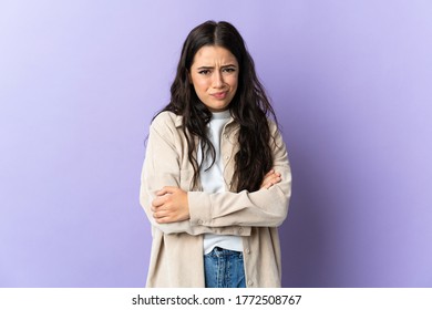 Young caucasian woman isolated on purple background with unhappy expression - Shutterstock ID 1772508767