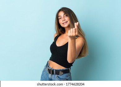 Young Caucasian Woman Isolated On Blue Background Making Money Gesture