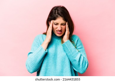 Young Caucasian Woman Isolated On Pink Background Having A Head Ache, Touching Front Of The Face.