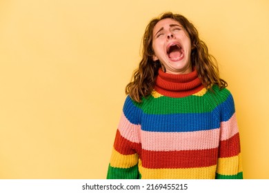 Young Caucasian Woman Isolated On Yellow Background Shouting Very Angry, Rage Concept, Frustrated.