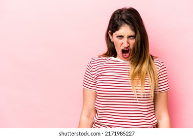 Young Caucasian Woman Isolated On Pink Background Shouting Very Angry, Rage Concept, Frustrated.