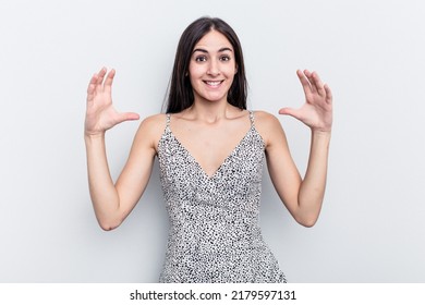 Young Caucasian Woman Isolated On White Background Holding Something With Palms, Offering To Camera.