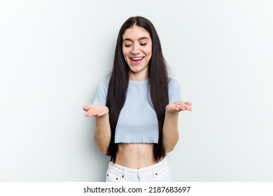 Young Caucasian Woman Isolated On White Background Holding Something With Palms, Offering To Camera.