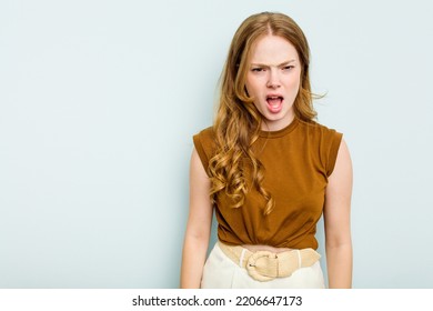 Young Caucasian Woman Isolated On Blue Background Shouting Very Angry, Rage Concept, Frustrated.