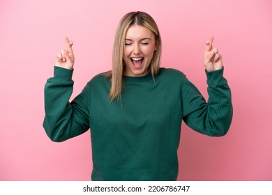 Young caucasian woman isolated on pink background with fingers crossing - Shutterstock ID 2206786747