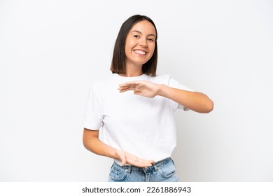 Young caucasian woman isolated on white background holding copyspace imaginary on the palm to insert an ad - Shutterstock ID 2261886943