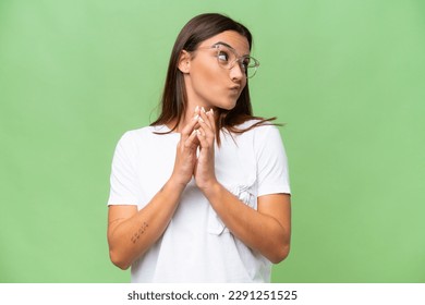 Young caucasian woman isolated on green chroma background scheming something - Powered by Shutterstock