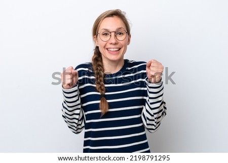 Young caucasian woman isolated on white background celebrating a victory in winner position