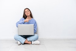 Young Caucasian Woman With Laptop Sitting On The Floor Isolated On White Background Giving A Thumbs Up Gesture