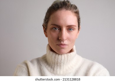 Young caucasian woman looking at the camera isolated on white background.