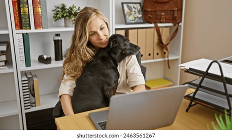 A young caucasian woman lovingly embraces her black labrador in a well-organized office interior. - Powered by Shutterstock