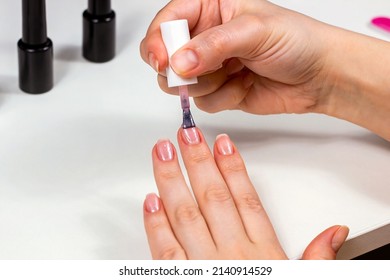 Young Caucasian Woman Making Self Manicure At Home With The Help Of Shellac Gel Polish And Other Tools For Nail Procedures