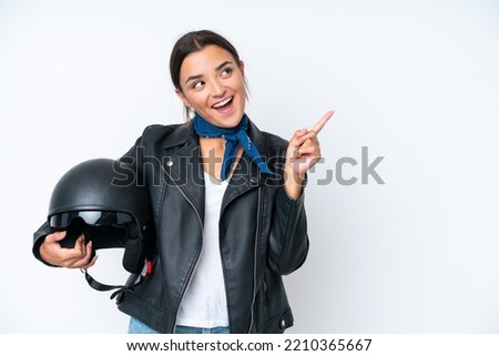 Young caucasian woman with a motorcycle helmet isolated on blue background intending to realizes the solution while lifting a finger up