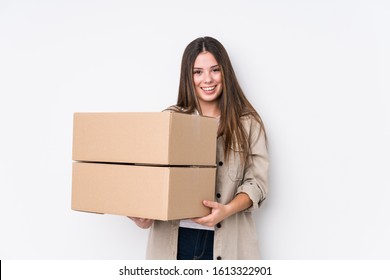 Young caucasian woman moving to a new home laughing and having fun.
