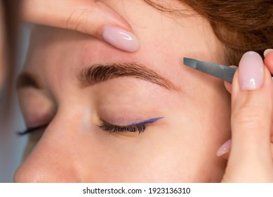 Young Caucasian Woman On The Brow Beauty Procedures. Professional Care For Face. Brows Coloring, Wax And Lamination
