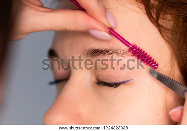 Young\
Caucasian Woman on the brow beauty procedures. Professional care\
for face. Brows coloring, wax and\
lamination\
