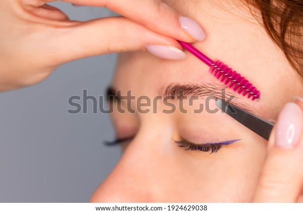 Young\
Caucasian Woman on the brow beauty procedures. Professional care\
for face. Brows coloring, wax and\
lamination\
