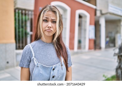 Young caucasian woman outdoors depressed and worry for distress, crying angry and afraid. sad expression. 