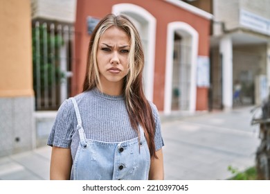 Young Caucasian Woman Outdoors Skeptic And Nervous, Frowning Upset Because Of Problem. Negative Person. 