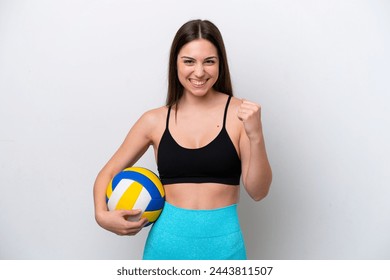 Young caucasian woman playing volleyball isolated on white background celebrating a victory in winner position - Powered by Shutterstock