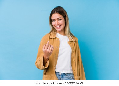 Young Caucasian Woman Pointing With Finger At You As If Inviting Come Closer.