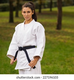 Young Caucasian Woman Practicing Judo Outdoors In A Park. 