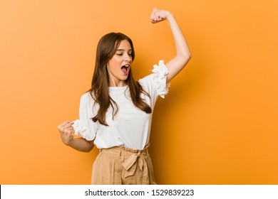 Young Caucasian Woman Raising Fist After A Victory, Winner Concept.