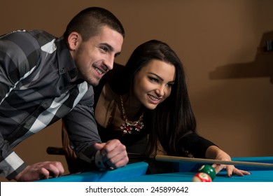 Young Caucasian Woman Receiving Advice On Shooting Pool Ball While Playing Billiards