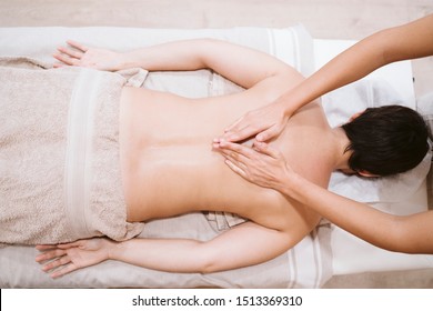 Young Caucasian Woman Receiving Back Massage From Physiotherapist Female In Clinic. Physiotherapy