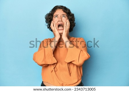 Young Caucasian woman with short hair whining and crying disconsolately.