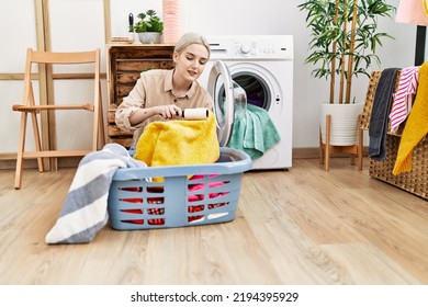 Young Caucasian Woman Smiling Confident Using Pet Hair Roller At Laundry Room