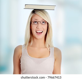 Young caucasian woman (student) with book on her head