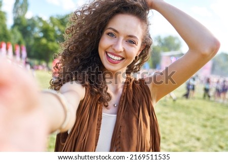Young caucasian woman taking selfie during music festival