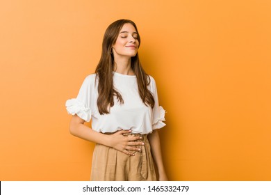 Young caucasian woman touches tummy, smiles gently, eating and satisfaction concept. - Shutterstock ID 1465332479