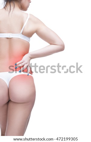 Young caucasian woman in underwear with backache, pain in the human body, isolated on white background with red dot, copy space