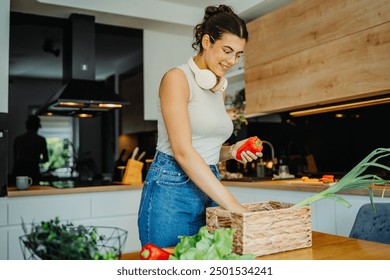 Young caucasian woman unpacking vegetables groceries from basket

 - Powered by Shutterstock