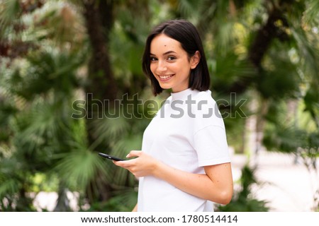 Young caucasian woman using a phone at outdoors