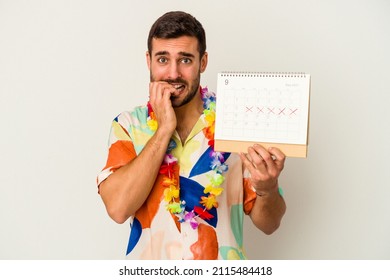 Young caucasian woman waiting for his vacations holding a calendar isolated on white background biting fingernails, nervous and very anxious.