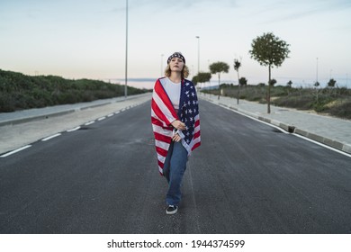 A Young Caucasian Woman Wearing A Bandana And A US Flag While Walking On The Road