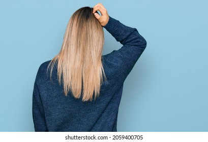 Young Caucasian Woman Wearing Casual Clothes Backwards Thinking About Doubt With Hand On Head 