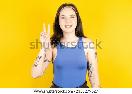 young caucasian woman wearing casual clothes showing and pointing up with fingers number two while smiling confident and happy.