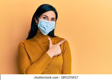 Young Caucasian Woman Wearing Medical Mask Smiling Cheerful Pointing With Hand And Finger Up To The Side 