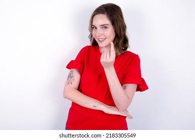 Young Caucasian Woman Wearing Red T-shirt Over White Background  Beckoning Come Here Gesture With Hand Inviting Welcoming Happy And Smiling