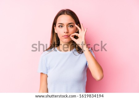 Young caucasian woman wearing a ski clothes isolated with fingers on lips keeping a secret.