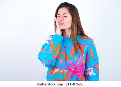 Young Caucasian Woman Wearing Vintage Colorful Sweater Over White Background With Toothache