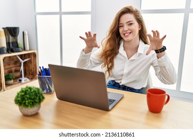 Young Caucasian Woman Working At The Office Using Computer Laptop Smiling Funny Doing Claw Gesture As Cat, Aggressive And Sexy Expression 