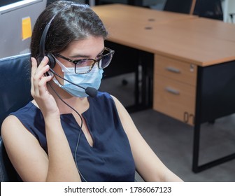 Young Caucasian Women Call Center Wear Headset And Mask Working With Laptop While Consulting Customers With Online Problems. Customer Service Executive Team Working At Office